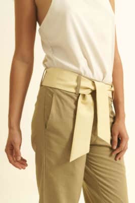 Mannequin on white background - Fair trade linen pants straight cut - beige color - beige wild silk belt - worn over white top - detail view