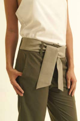 Mannequin on white background - Fair trade linen pants straight cut - green color - gray wild silk belt - worn over white top - detail view