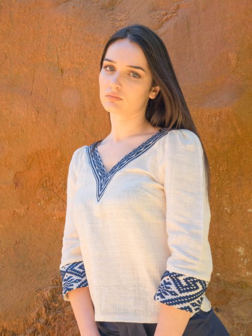 Femme portant blouse coton bio blanche et tissages traditionnels bleus