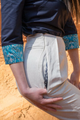 woman wearing cream linen pants flat pliers pocket detail