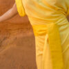 woman wearing traditional silk yellow wrap dress